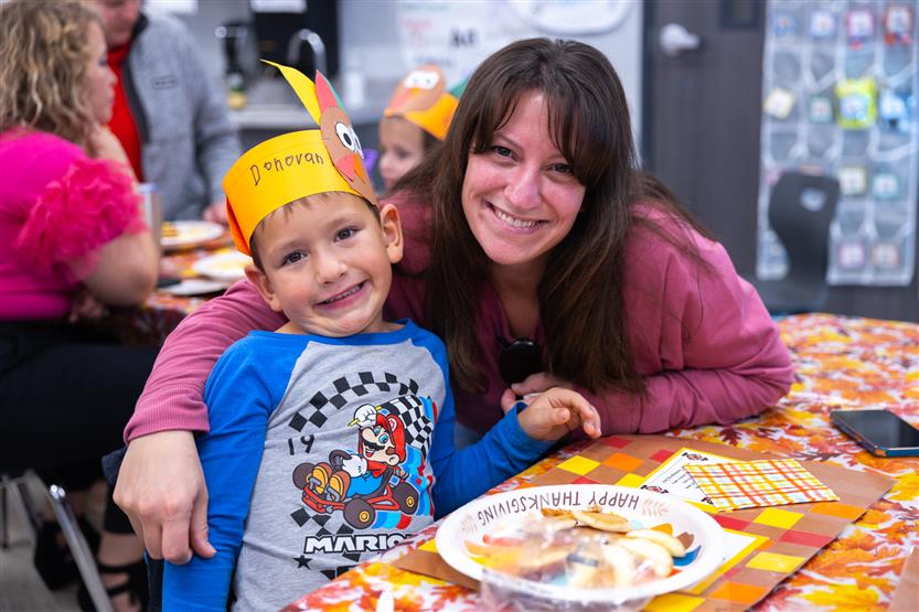 Creekside kindergartners and their families enjoy breakfast